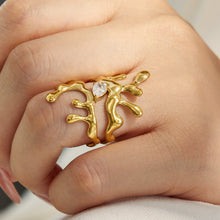 Model wearing a gold 316L stainless steel irregular CZ statement ring with sculptural design