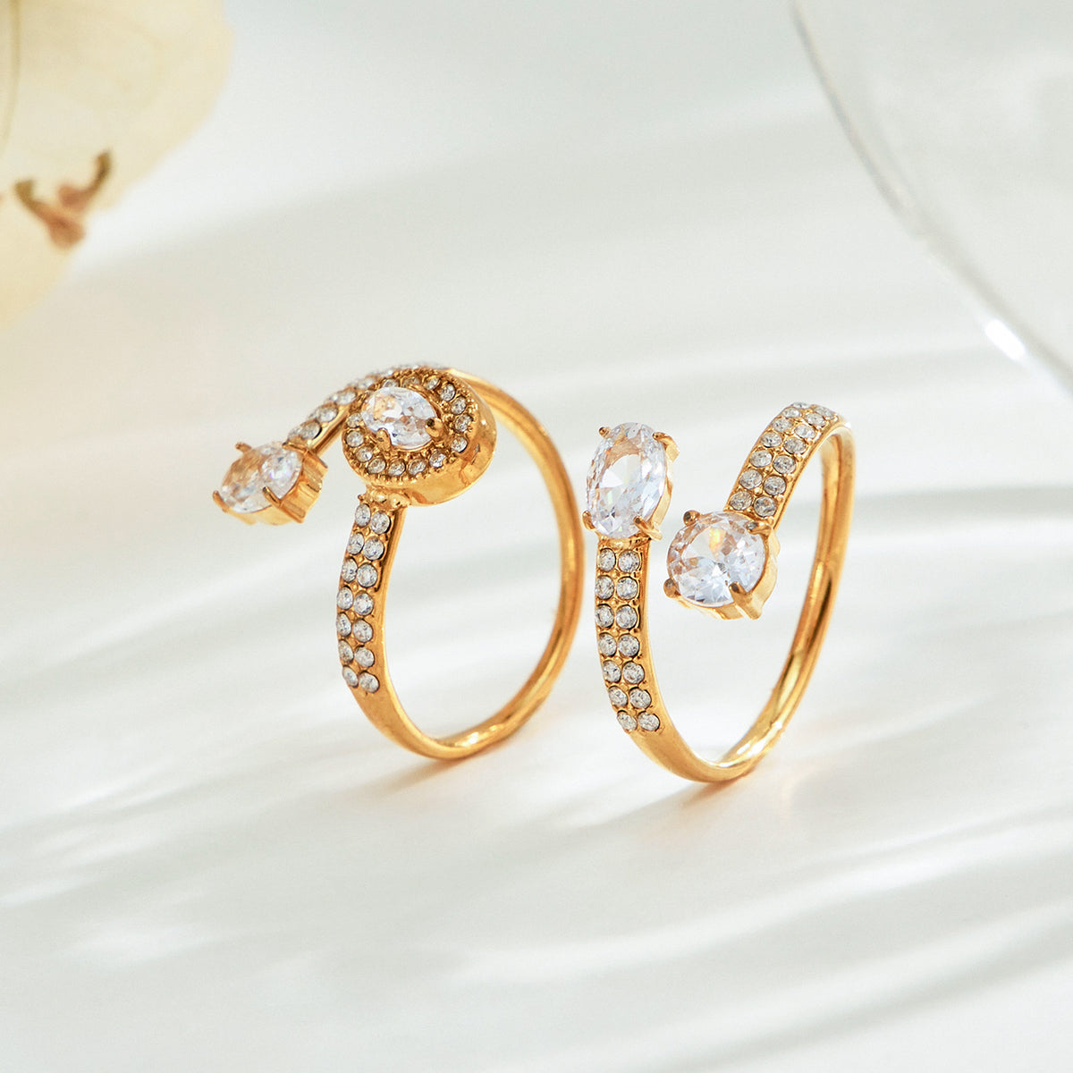 Gold-tone stainless steel CZ open ring shown from the side with adjustable band design