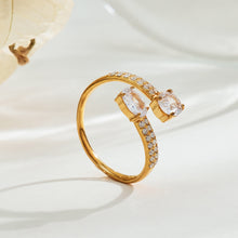 Two gold-tone stainless steel CZ adjustable open ring designs displayed side by side