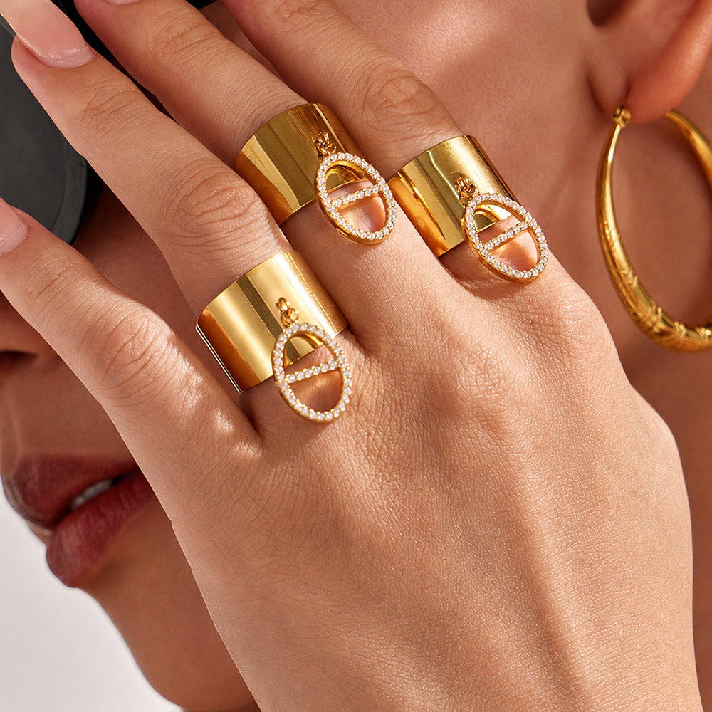 Fashion close-up of gold CZ pendant open ring worn on hand for statement jewelry displays