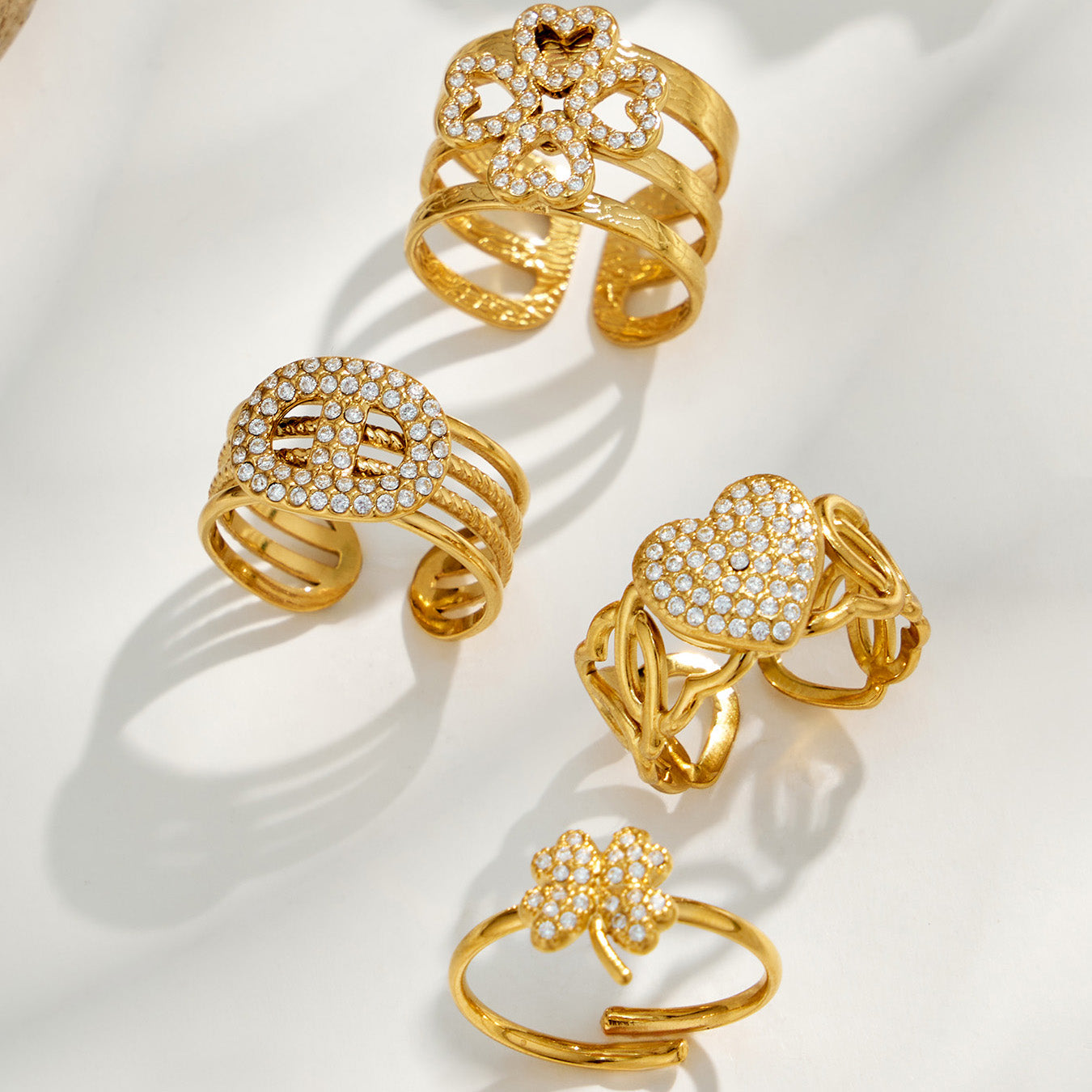 Collection of gold cubic zirconia statement open rings in floral heart and sculptural styles