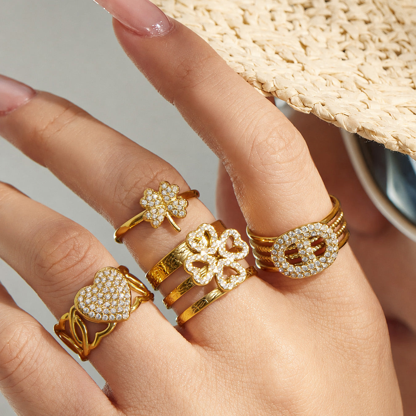 Model wearing several gold 316L stainless steel cubic zirconia statement open rings