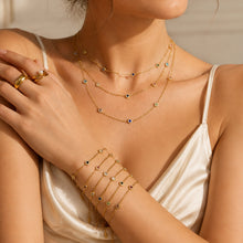 Model wearing a gold-tone bezel-set cubic zirconia station necklace