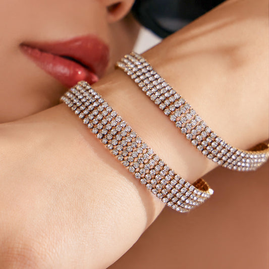 Gold CZ tennis bracelets worn on model wrist for evening outfit, party jewelry and boutique bracelet wholesale styling