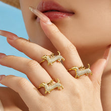 Gold dachshund zircon necklaces and rings arranged together for a boutique jewelry assortment