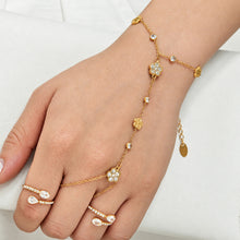 Dainty gold-tone stainless steel flower hand chain bracelet worn on hand