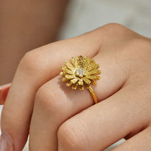 Close-up of a model wearing a gold daisy flower ring in 316L stainless steel