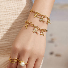 Gold deer charm bracelet with a zircon reindeer centerpiece worn on the wrist