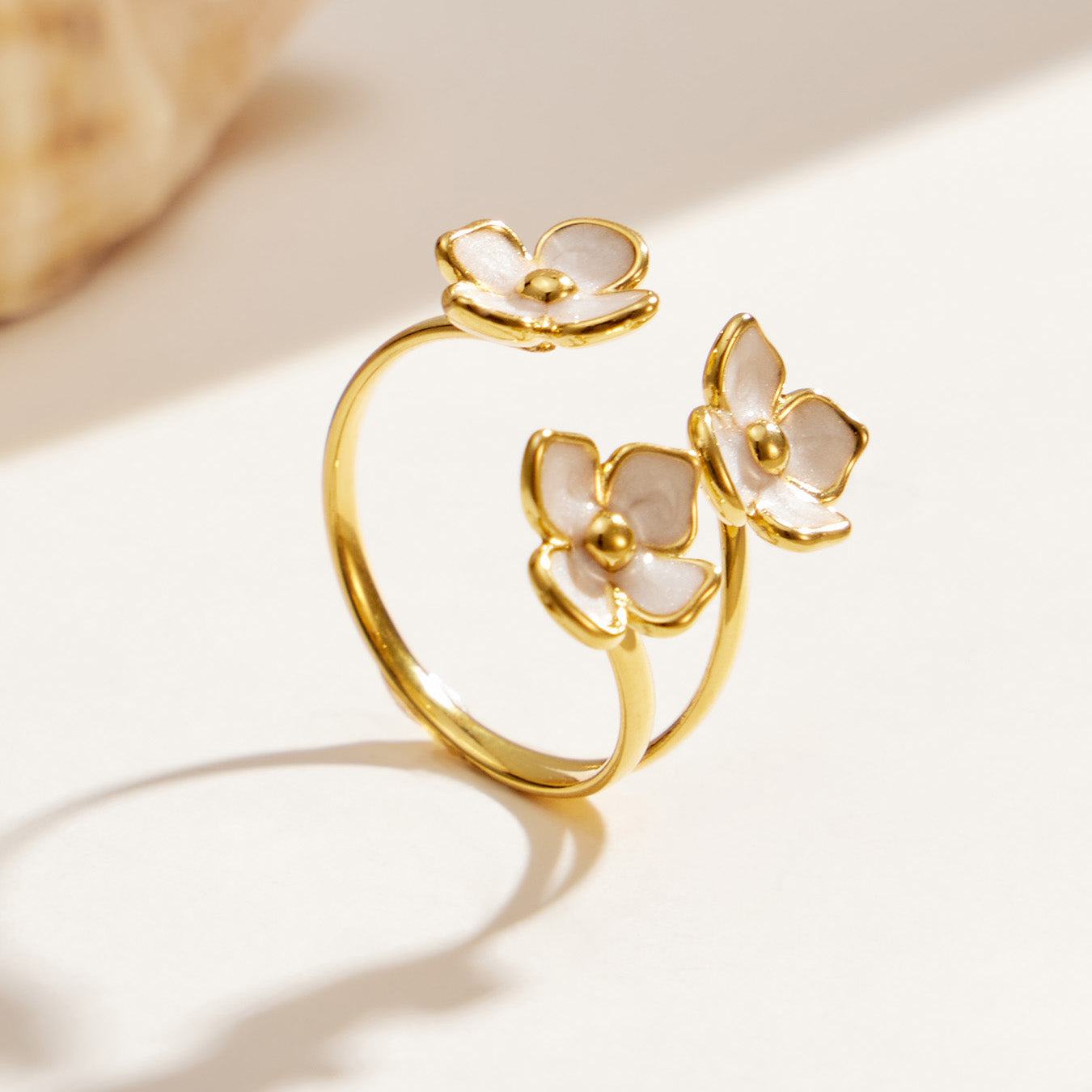 Gold enamel flower open ring in 316L stainless steel with delicate botanical design