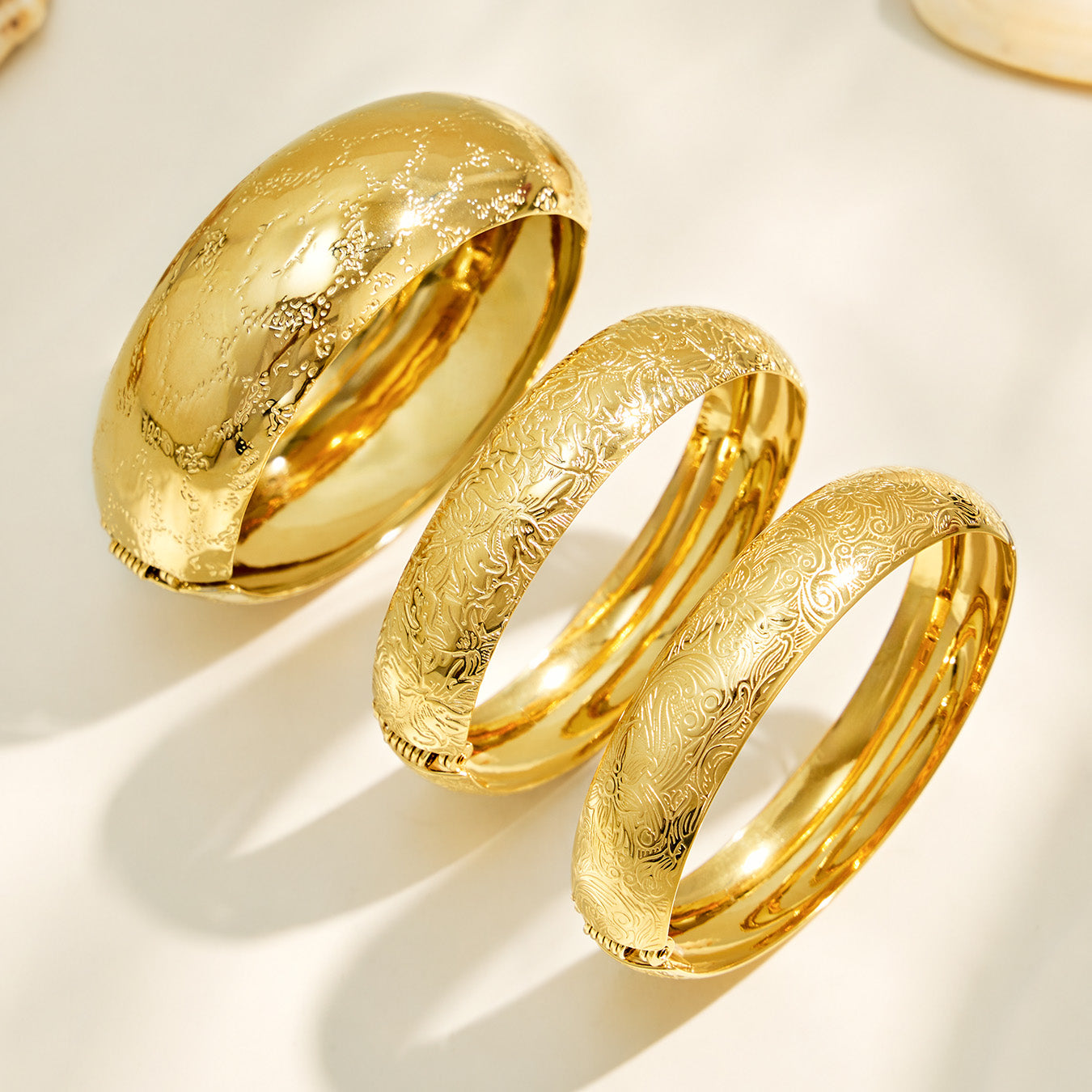 Close-up detail of a gold floral engraved bangle surface