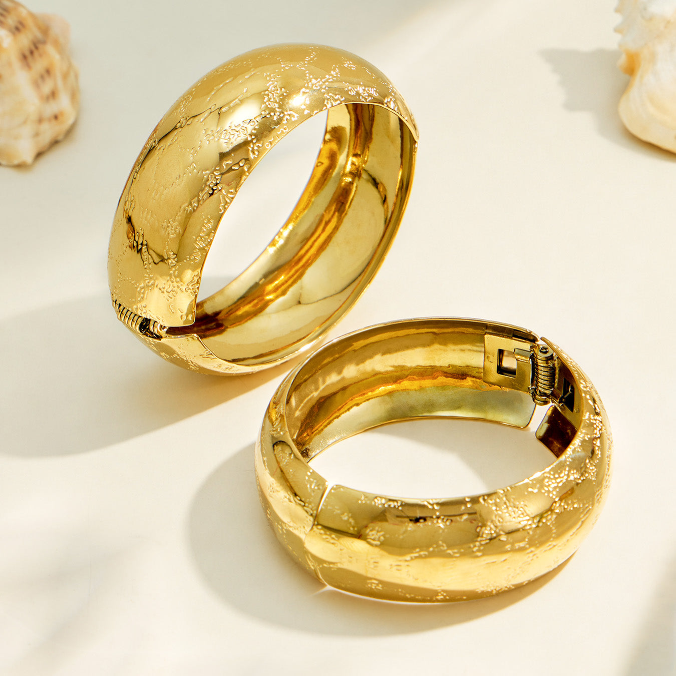 Inner and side detail of a gold floral engraved wide bangle