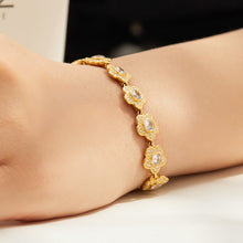 Gold floral cubic zirconia bracelet shown from side view on wrist