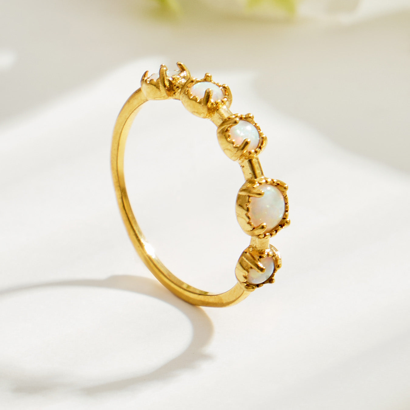 Angled product view of a feminine floral ring in 316L stainless steel and 18K PVD gold