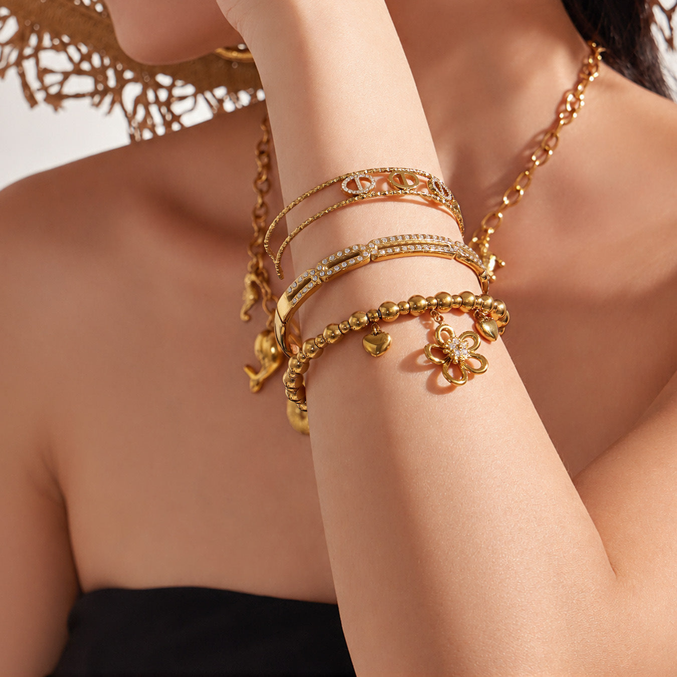 Gold flower heart zircon bangles worn on wrist with sparkly 5A zircon details for boutique bracelet styling