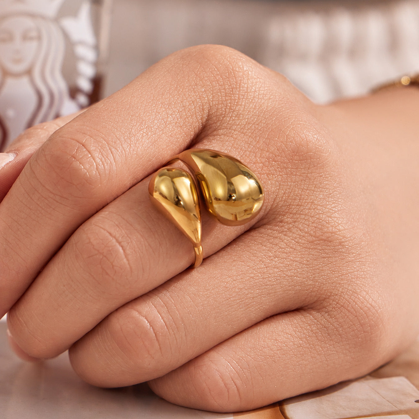 Gold flower statement ring worn on hand with bold open ring design for boutique jewelry styling