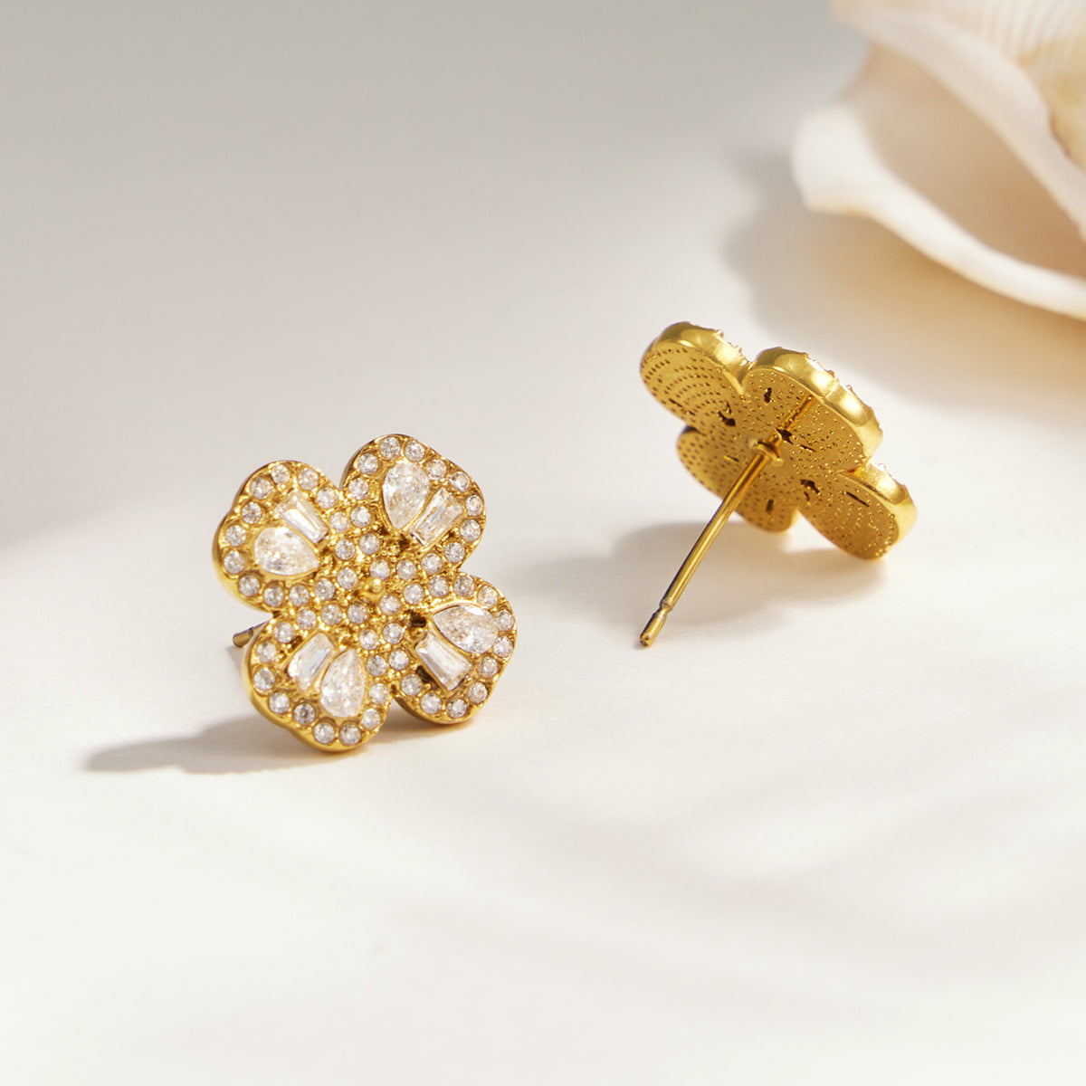 Gold-tone four-petal flower zircon stud earrings with pavé floral detail