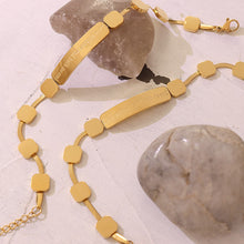 Gold geometric bar chain bracelet styled in a lifestyle jewelry setting