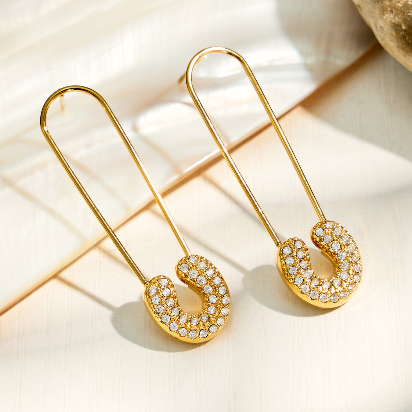 Gold geometric drop earrings with elongated paperclip-inspired design