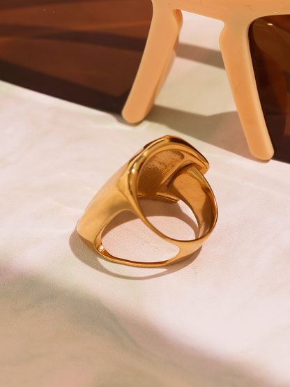 Gold geometric wide band ring side profile showing open back and bold curved shape