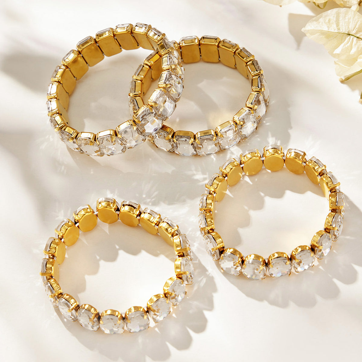 Assorted gold-tone stretch bracelets with clear faceted glass rhinestones