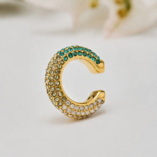Gold no-piercing ear cuff with green cubic zirconia accents