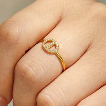 Close-up of a gold heart CZ open ring in 316L stainless steel worn on a model finger