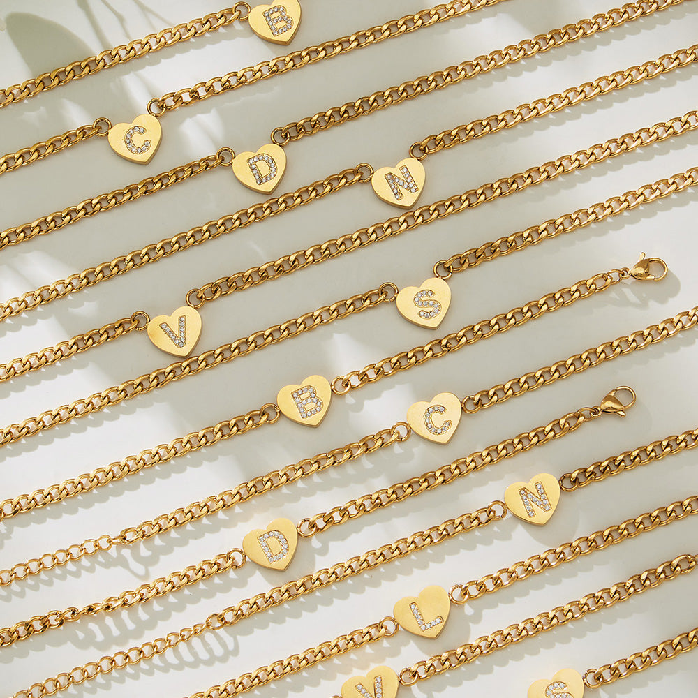 Gold-tone zircon initial heart necklaces arranged in multiple letter variants for wholesale jewelry