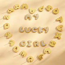 Gold initial letter stud earrings arranged in a heart around the word Lucky