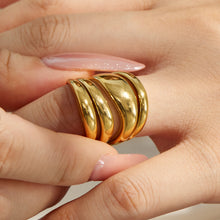 Gold tone irregular multi-band 316L stainless steel ring shown in a hand close-up