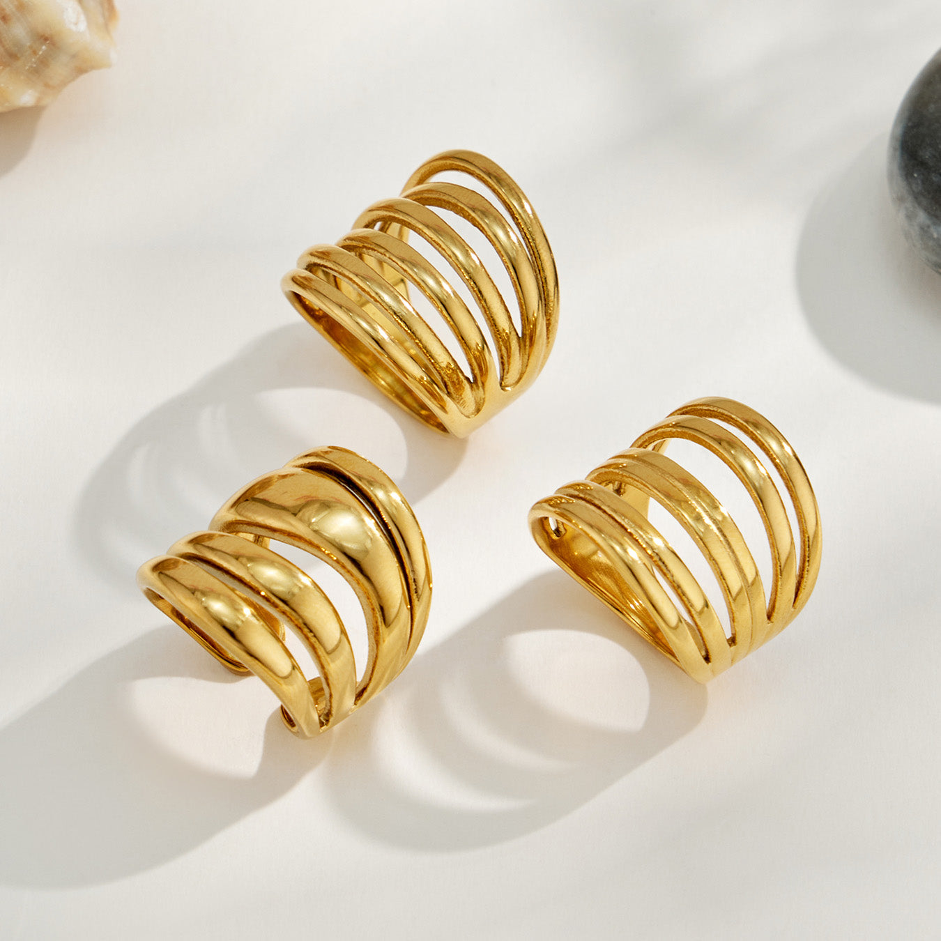 Three gold tone 316L stainless steel irregular open rings in different multi-band styles