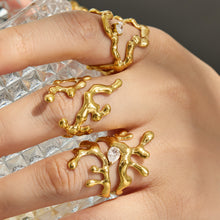 Model wearing multiple gold 316L stainless steel irregular statement rings on the hand