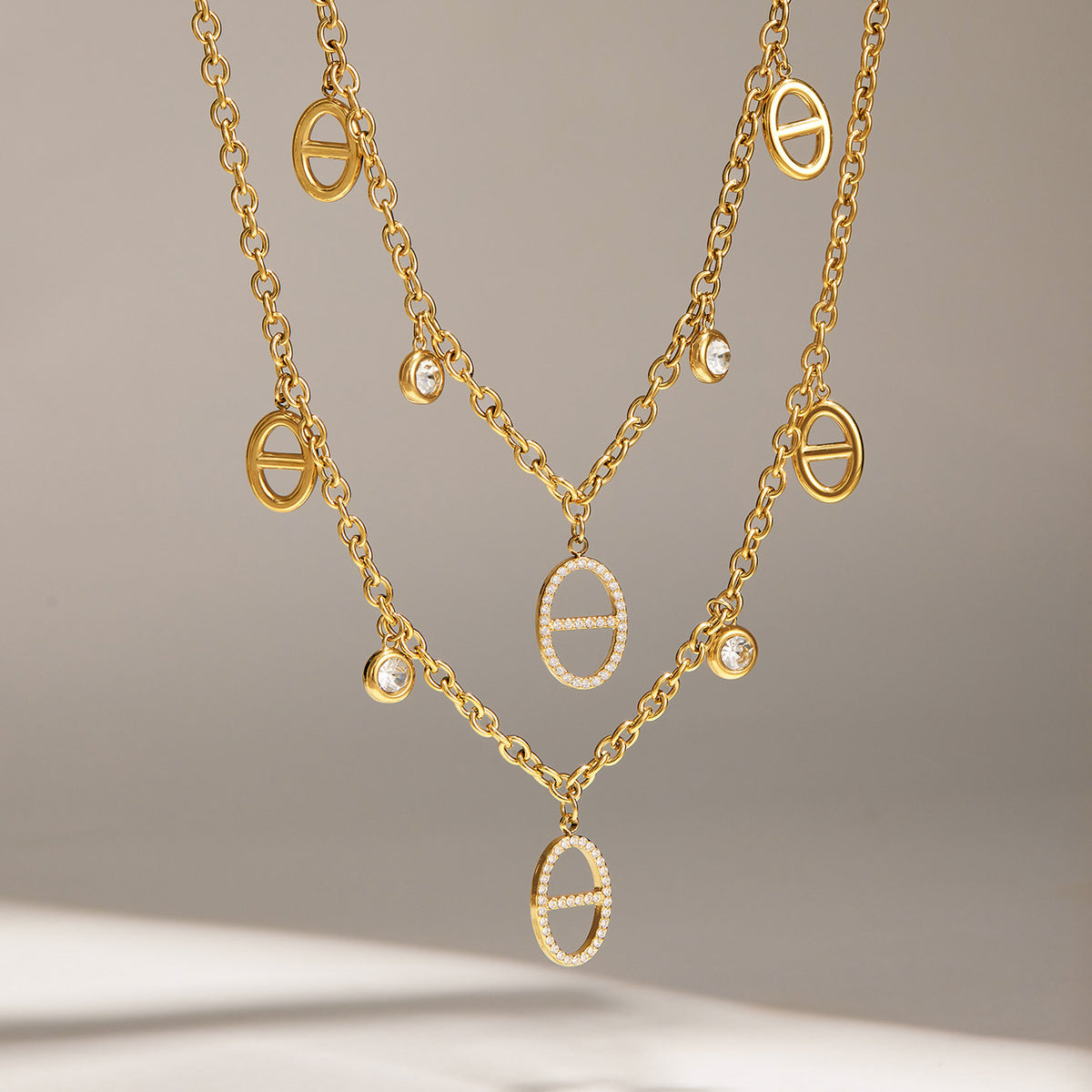 Gold stainless steel zircon charm necklaces styled in a layered display