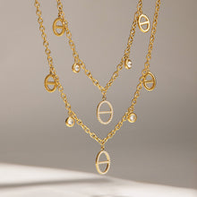 Gold stainless steel zircon charm necklaces styled in a layered display