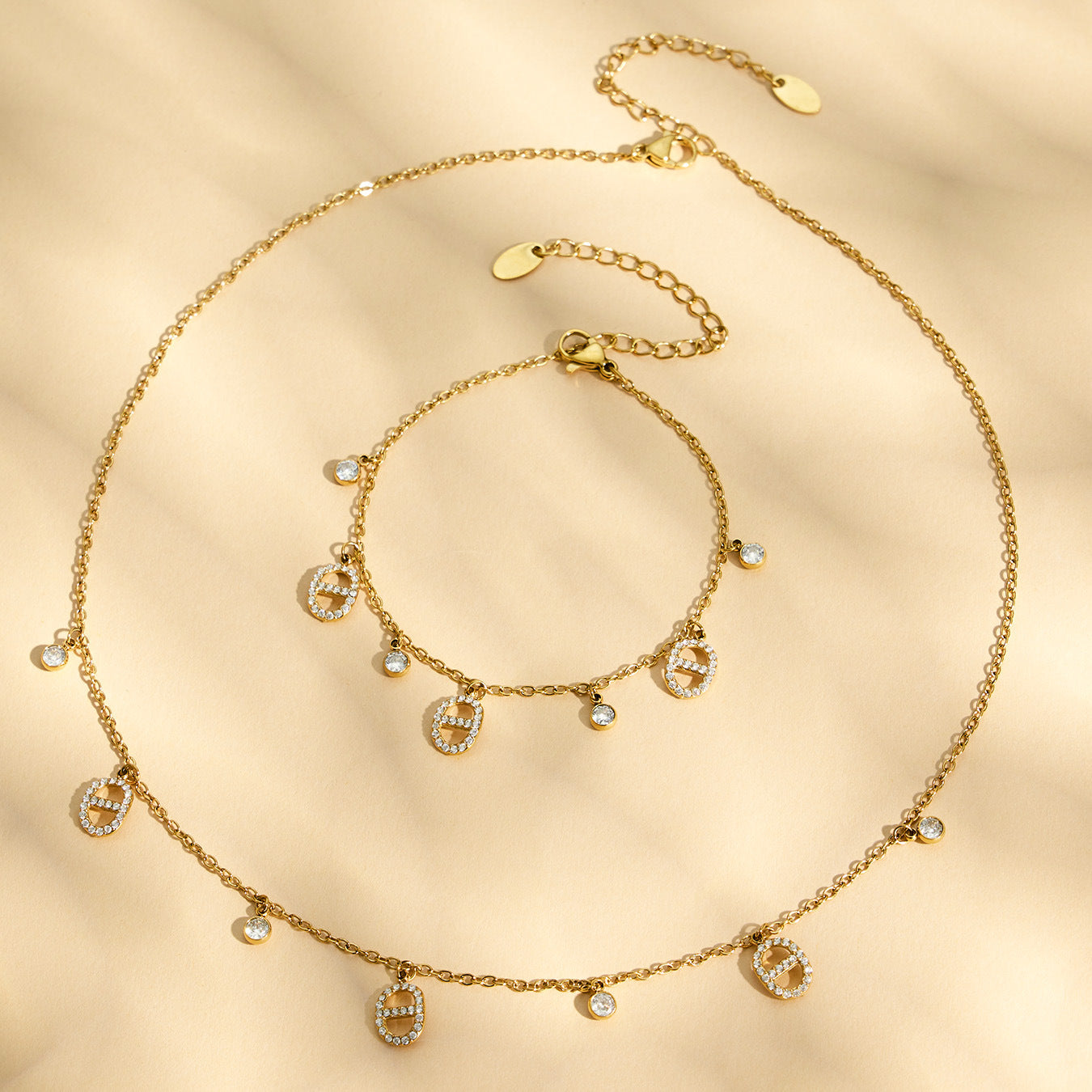 flat lay of 18K gold coin charm layered necklace set stainless steel jewelry