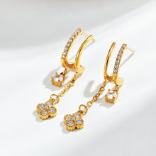Gold-tone stainless steel long CZ dangle earrings displayed for wholesale buyers