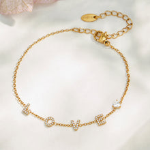 Gold LOVE letter zircon bracelet with adjustable extender chain in a flat lay