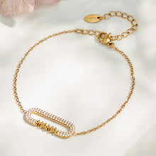 Gold MAMA zircon bar bracelet with an adjustable extender chain on soft fabric