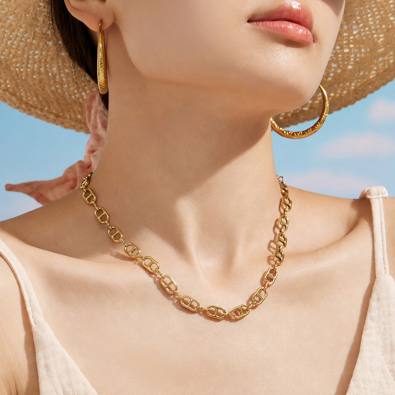 Close-up of a model wearing a gold mariner chain link necklace