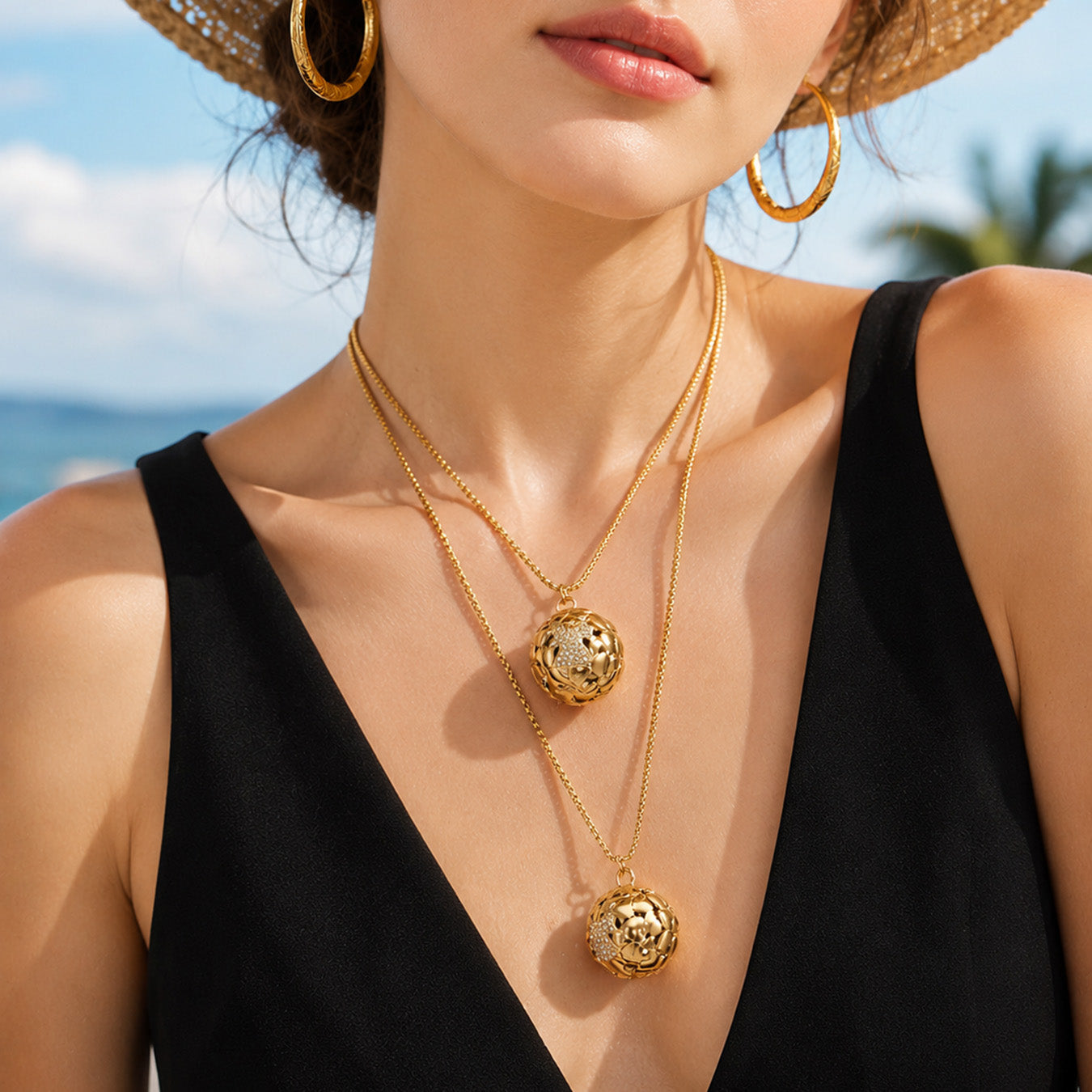 Gold round medallion pendant necklace worn by a model against a blue background
