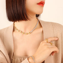 Model wearing a gold-tone mixed-link zircon necklace with the coordinating bracelet