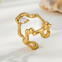 Gold 316L stainless steel molten organic open ring displayed on a clean light background
