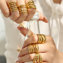 Model wearing gold tone 316L stainless steel multi-band open statement rings