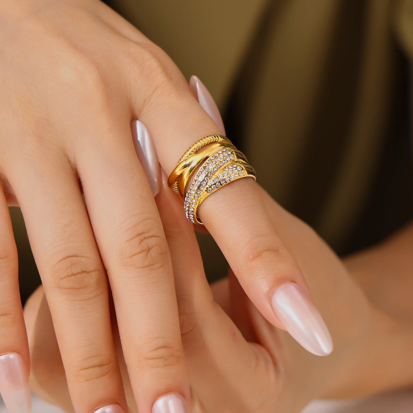 Close-up of a model wearing a gold multi-row statement ring