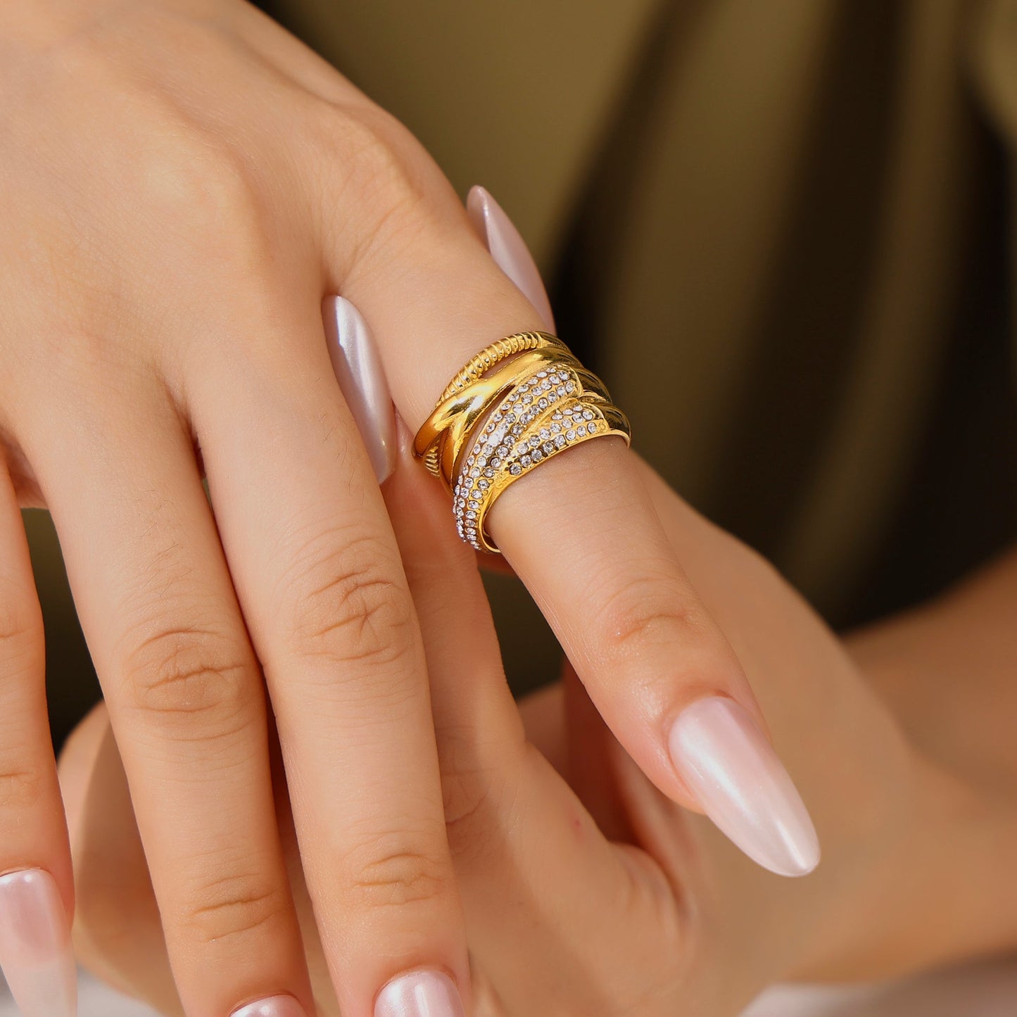 Close-up of a model wearing a gold multi-row statement ring