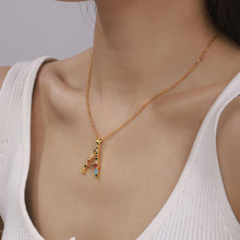 Close-up of gold multicolor zircon letter A necklace on model, colorful initial pendant necklace for personalized jewelry