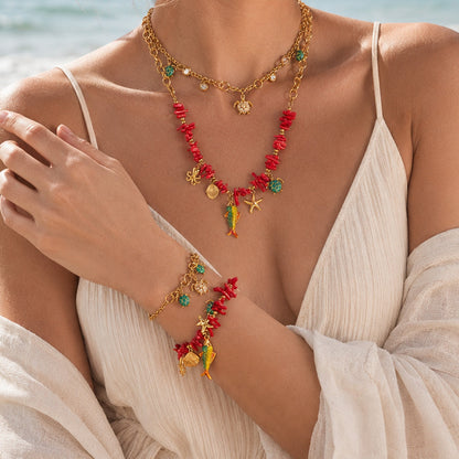 Model wearing gold ocean animal charm necklace with turtle and marine-inspired pendants for summer vacation jewelry styling
