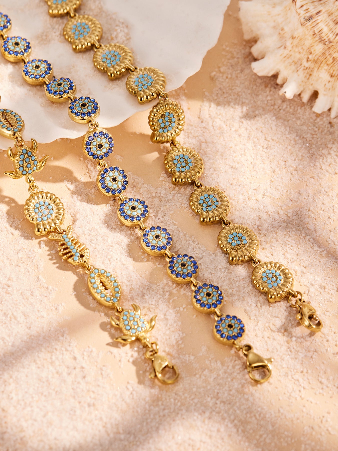 Gold ocean bracelet stack with blue zircon details for beach boutiques and vacation jewelry displays