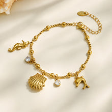 Gold ocean charm bracelet with shell, seahorse and clear cubic zirconia accents