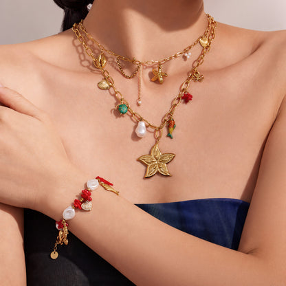 Model wearing layered gold ocean charm necklaces with starfish and fish tail pendants for summer vacation jewelry styling