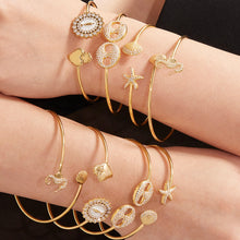 Model wearing stacked gold 5A zircon ocean bangles, trendy INS summer accessory